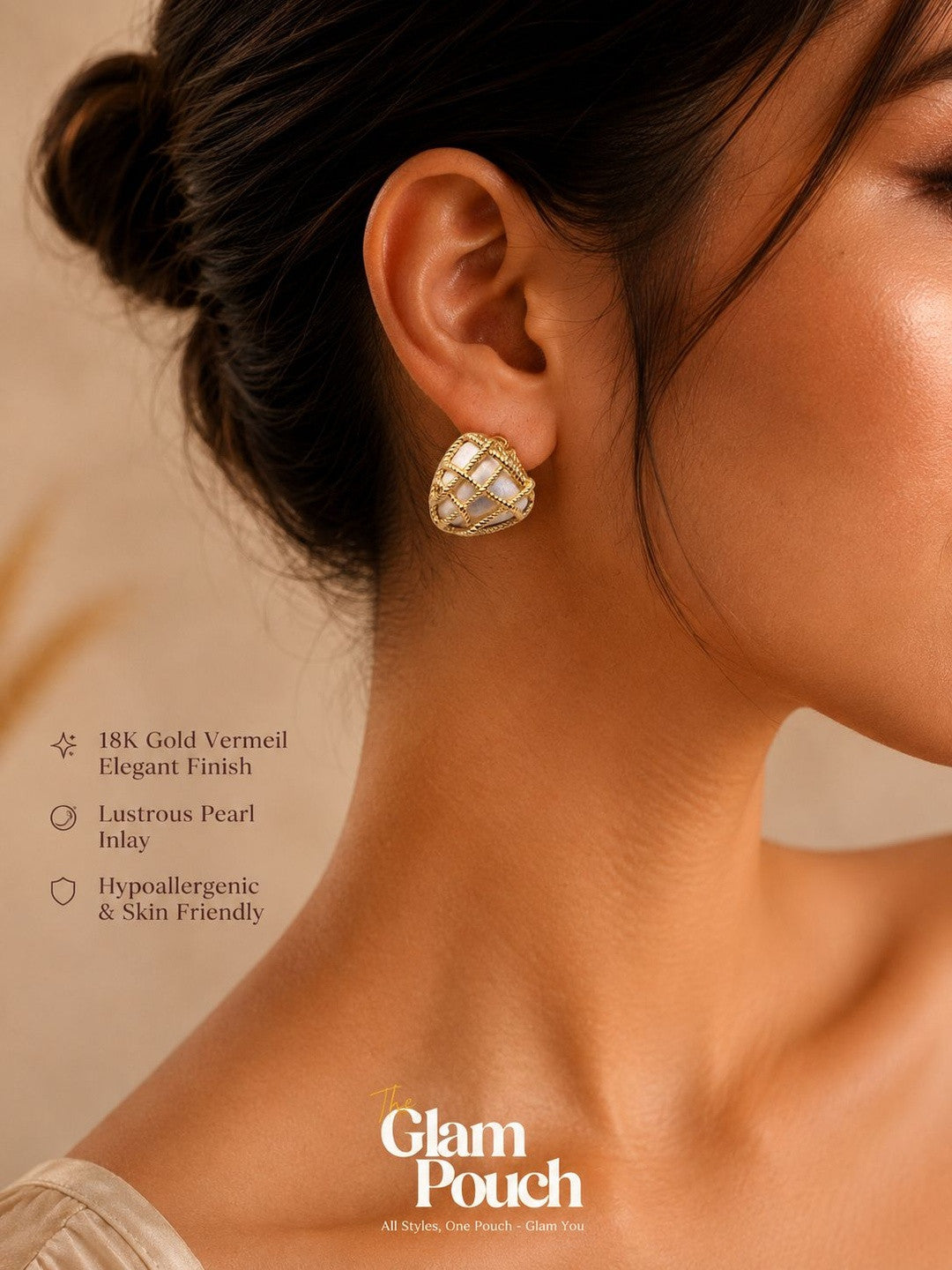 Woman wearing a gold vermeil pearl inlay heart stud earring with hair in an updo against a warm beige background