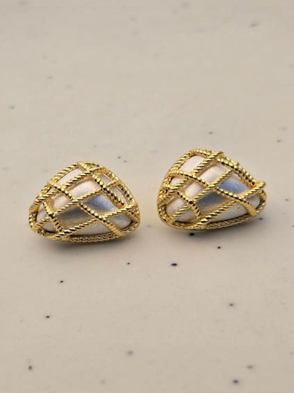 Two gold twisted rope heart stud earrings with lustrous pearl inlay panels on a light speckled background