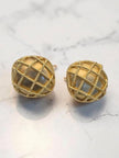 Gold lattice dome stud earrings with iridescent shell inlay displayed on a white marble background
