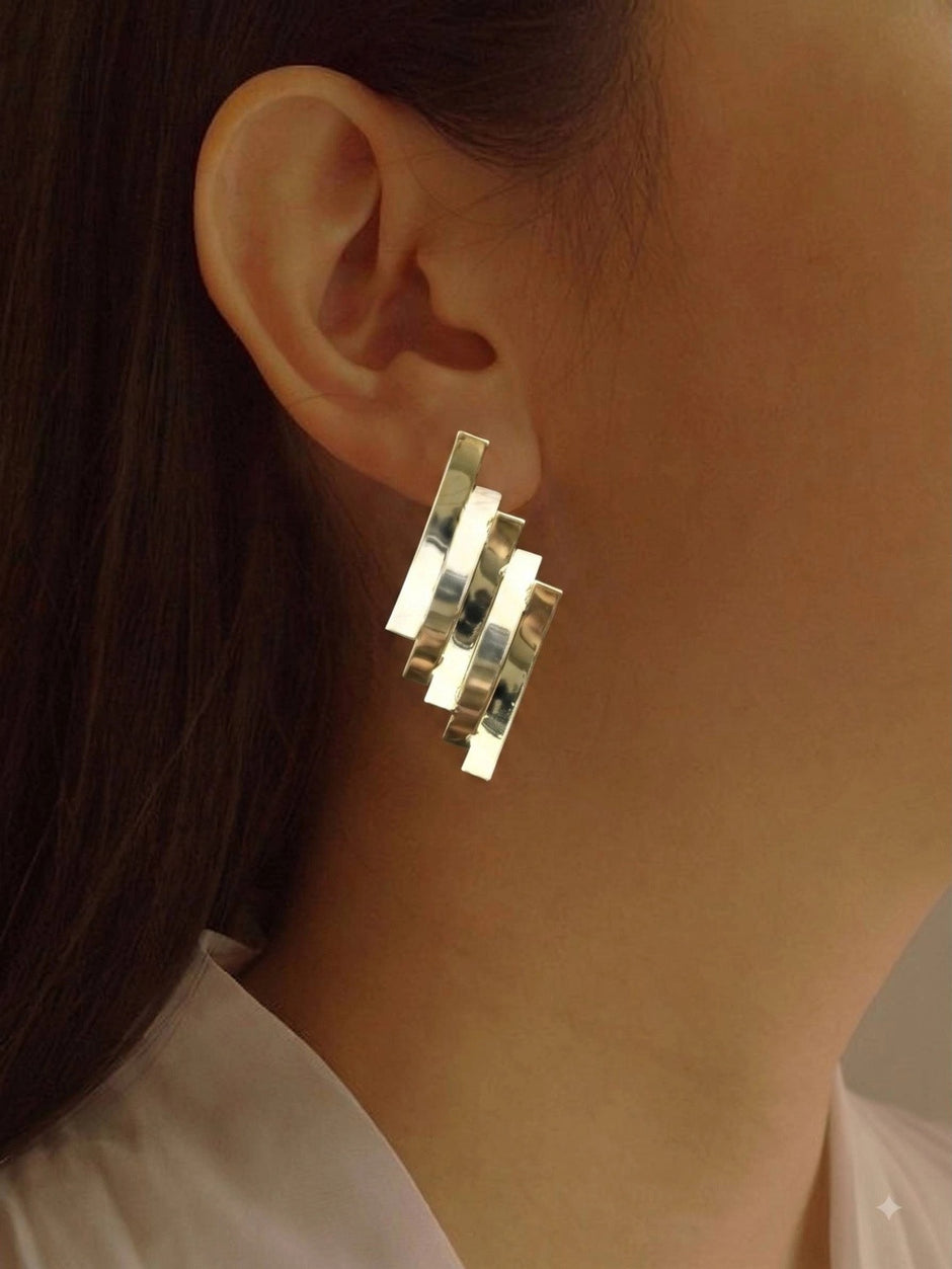 Gold layered bar stud earring worn on a model's ear showing scale and fit