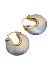 Two chunky two-tone hoop earrings with wide brushed silver disc and gold clasp shown flat on white background