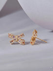 Side profile of gold-plated bow stud earring showing post and butterfly fastening