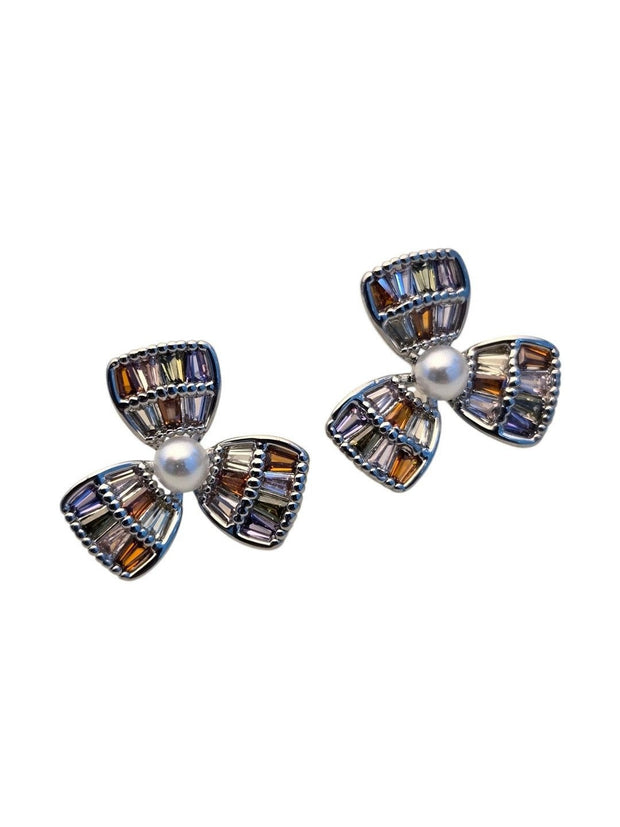 Front view of multicolour CZ baguette flower stud earrings with faux pearl centre on white background