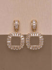 Gold-plated baguette CZ earrings showing circular and square pendant styles on pink surface