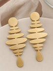Pair of matte gold geometric drop earrings with stacked oval discs and teardrop end displayed on a beige surface