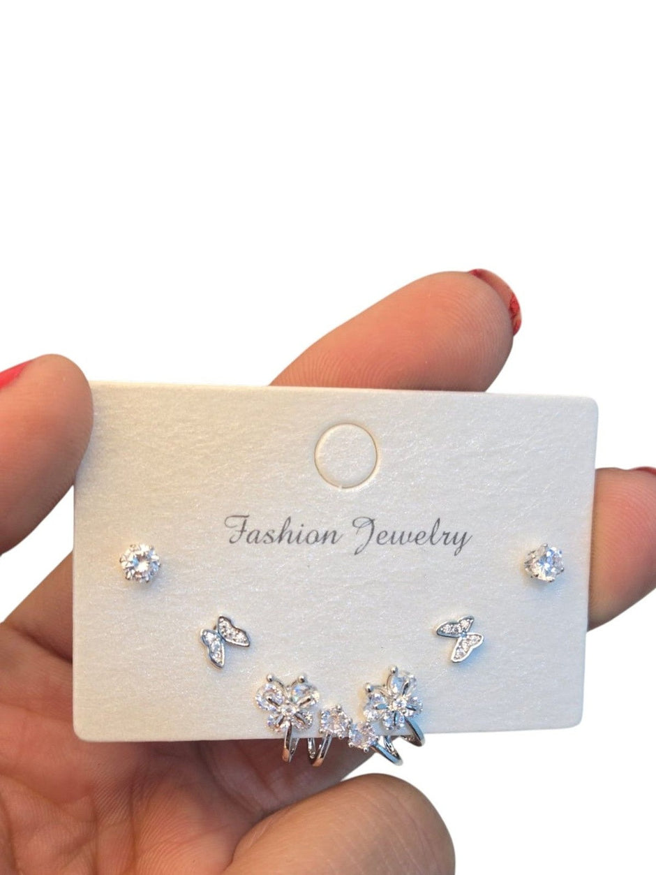 Close-up of Fashion Jewelry card showing round solitaire studs, butterfly pavé studs and floral ear cuff on white background