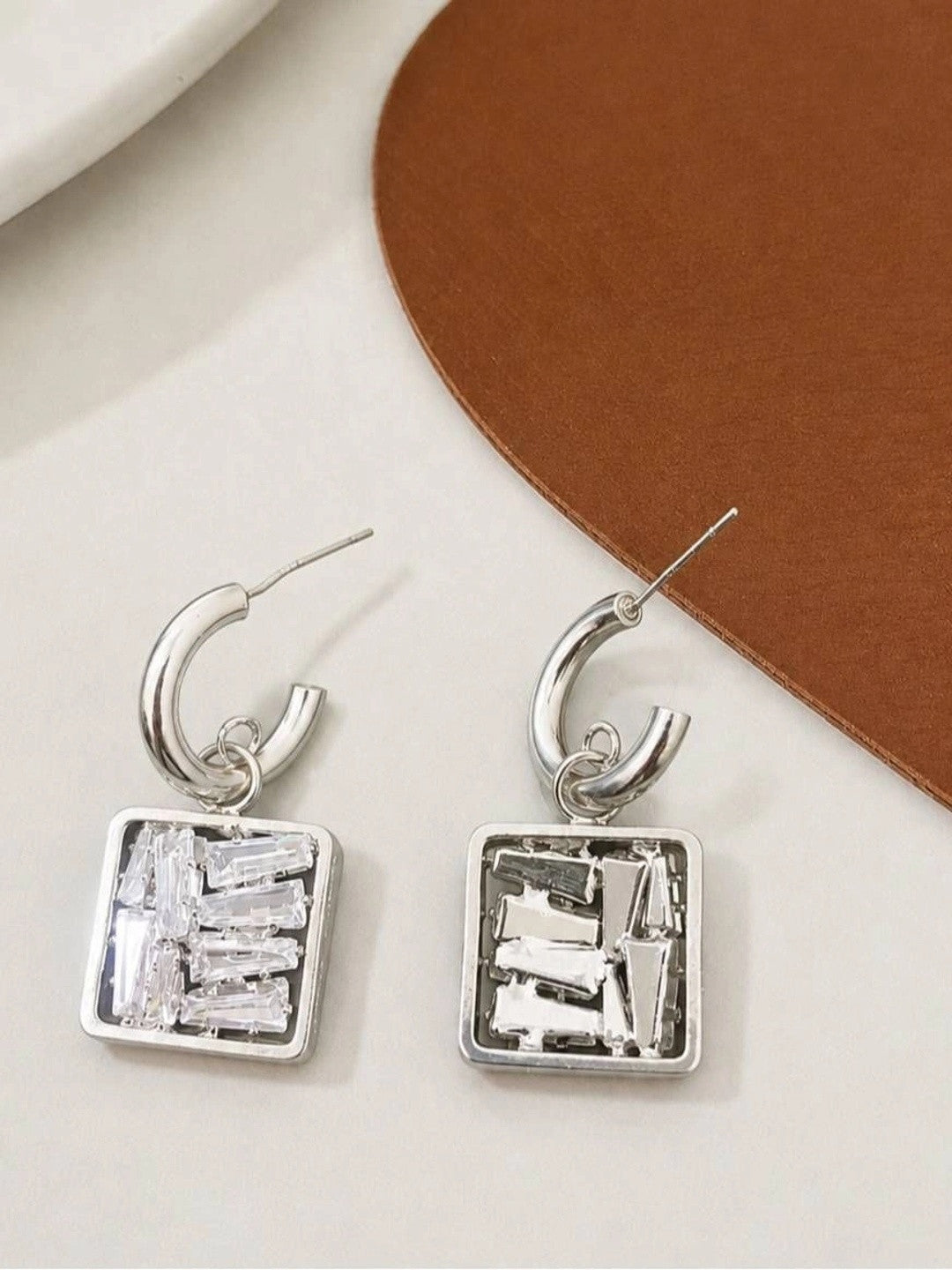 Front and back view of silver square drop earrings showing stud closure and stone setting detail