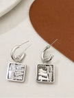 Front and back view of silver square drop earrings showing stud closure and stone setting detail
