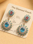 Pair of gold-tone aqua blue zircon drop earrings displayed on branded jewellery card