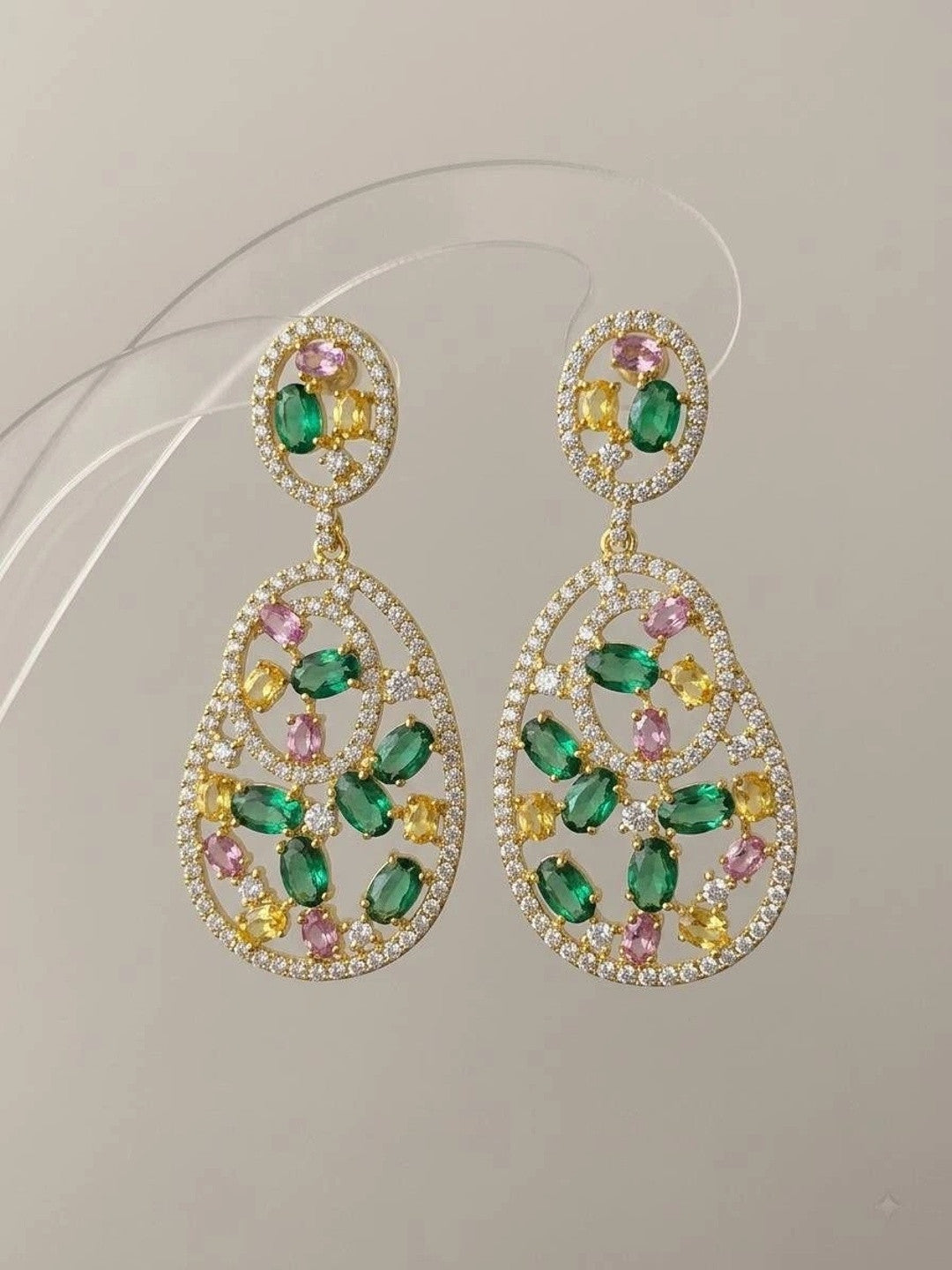 Front-facing pair of gold-plated CZ drop earrings showing green pink and yellow stones on neutral background