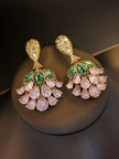 Front view of both gold-plated pink crystal drop earrings displayed on a round black stand