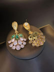 Side-by-side front and back view of gold-plated pink crystal earrings on a dark display stand