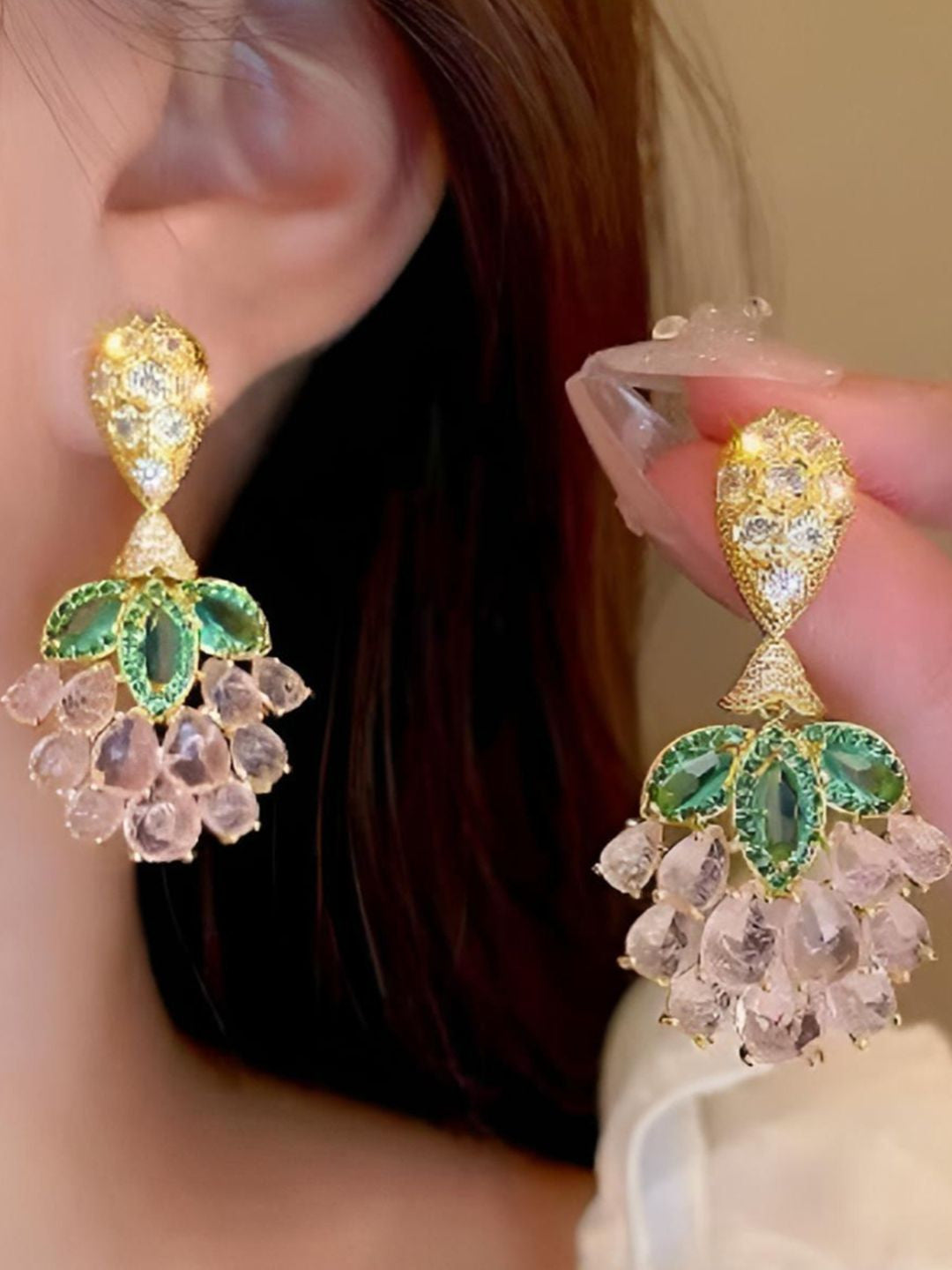 Macro detail of honeycomb white zirconia stud top and green leaf motif on gold-plated earring
