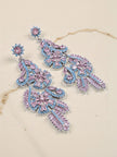 Pink and blue CZ chandelier earrings displayed on a cream marble surface showing full drop length