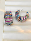 Front and side view of rainbow zirconia ribbed hoop earrings displayed on a white jewellery tray