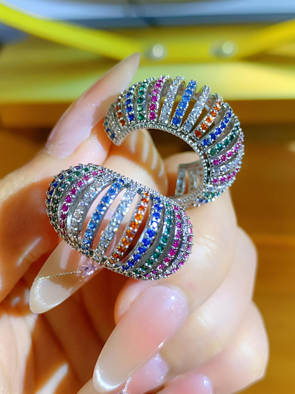 Both multicolour zirconia chunky hoops held in palm showing open ribbed band construction and stone detail