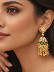 Close-up of gold-plated emerald and white CZ chandelier earring worn on a model showing scale and drape