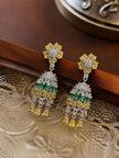 Pair of chandelier drop earrings resting on carved decorative tray showing full tiered front view