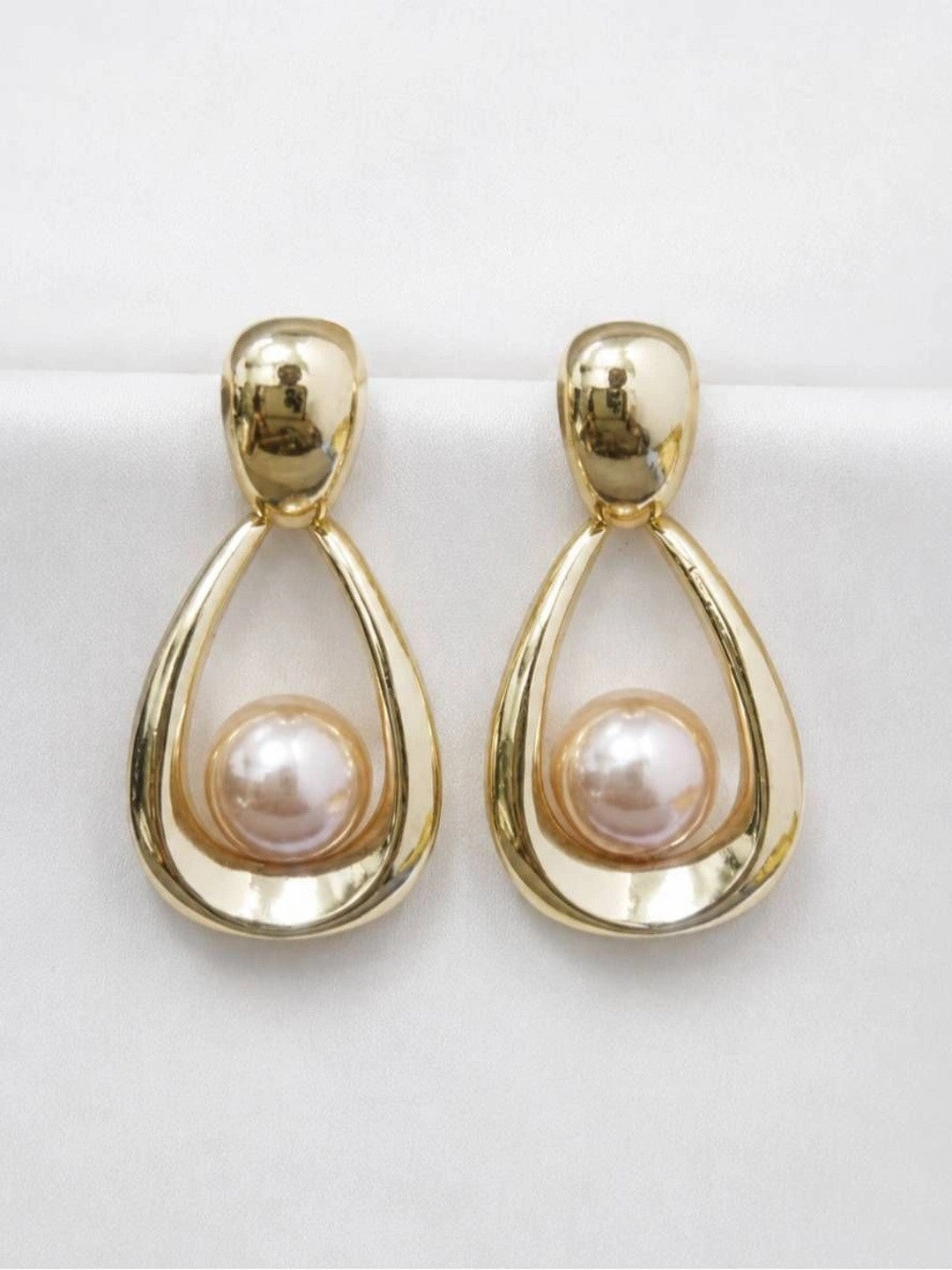 Front view of both gold teardrop hoop earrings with pink-toned faux pearl centres on white background