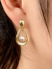 Single gold-plated pearl teardrop earring worn on a model's ear showing drape and scale