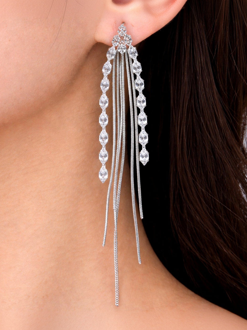 Silver crystal tassel earring worn on a woman's ear showing full drop length