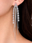 Silver crystal tassel earring worn on a woman's ear showing full drop length