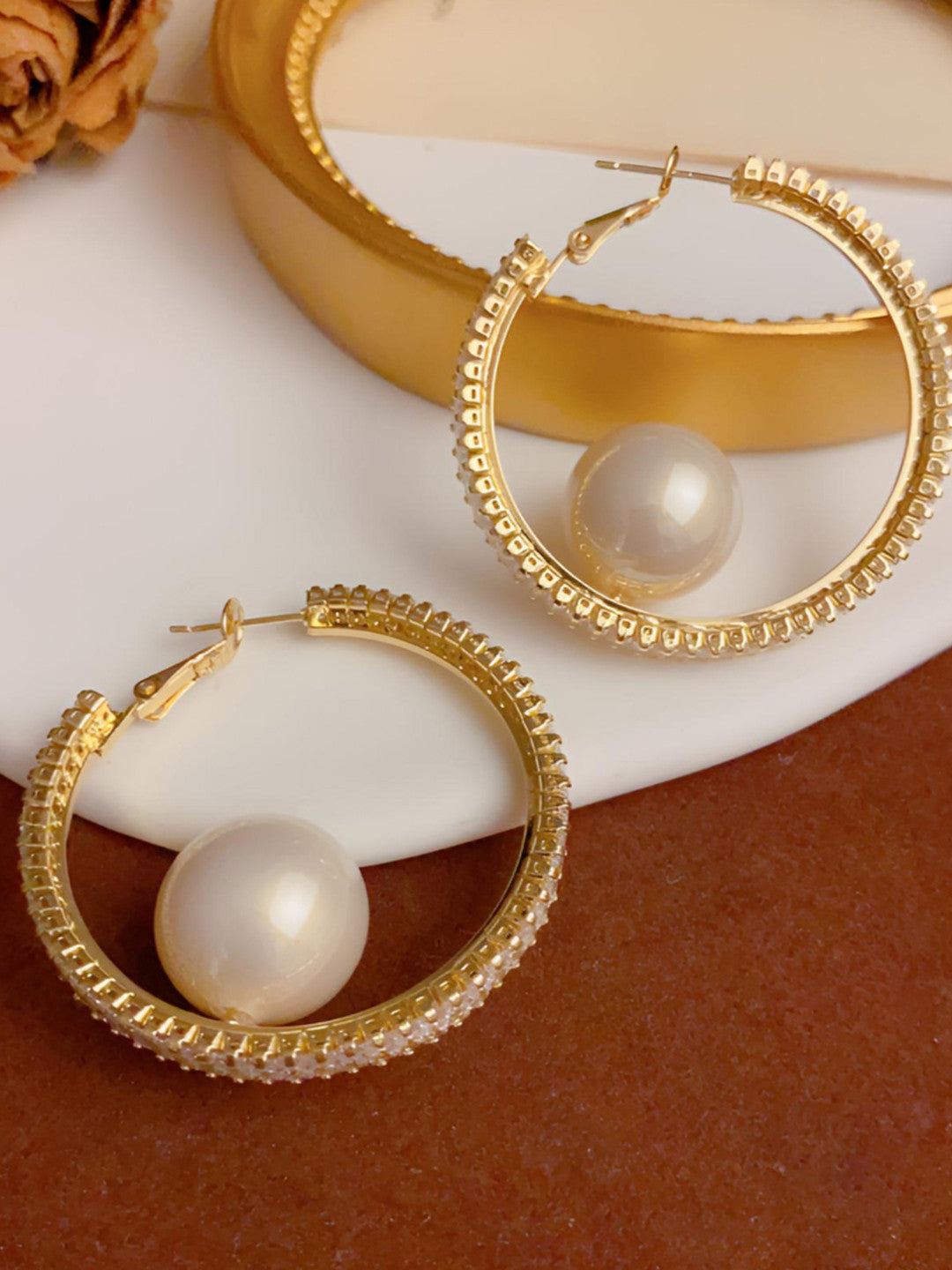 Top-down view of gold CZ pearl hoops showing click-top clasp and full hoop detail