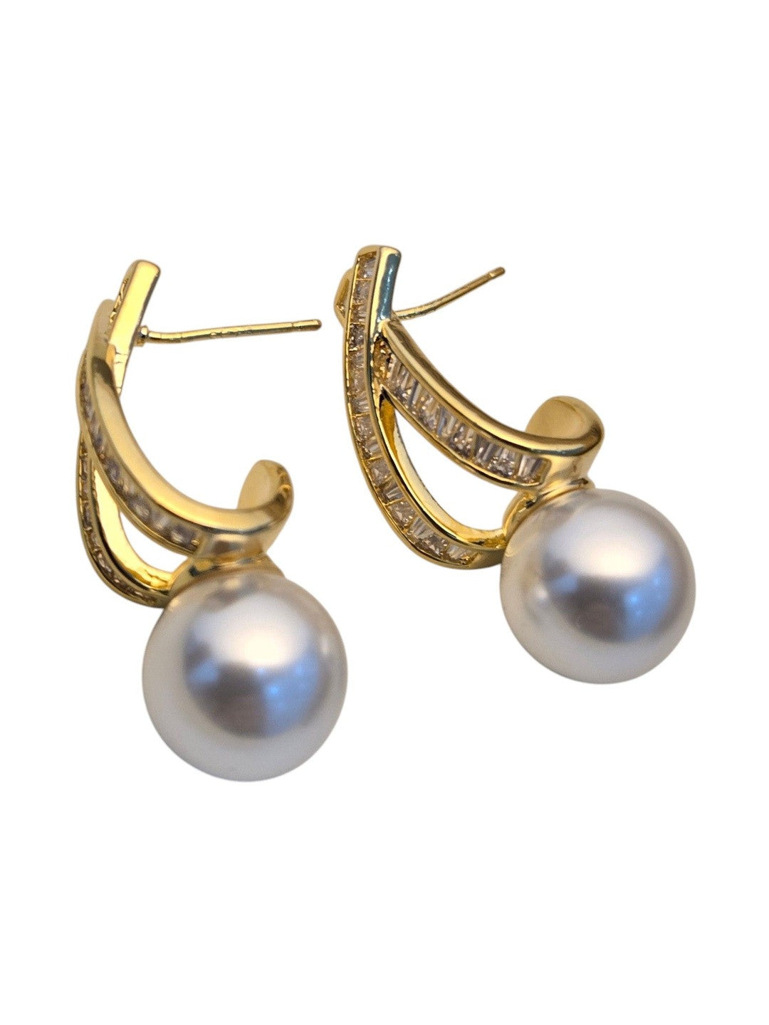Gold-plated faux pearl drop earrings with channel-set baguette arc shown against a clean white background