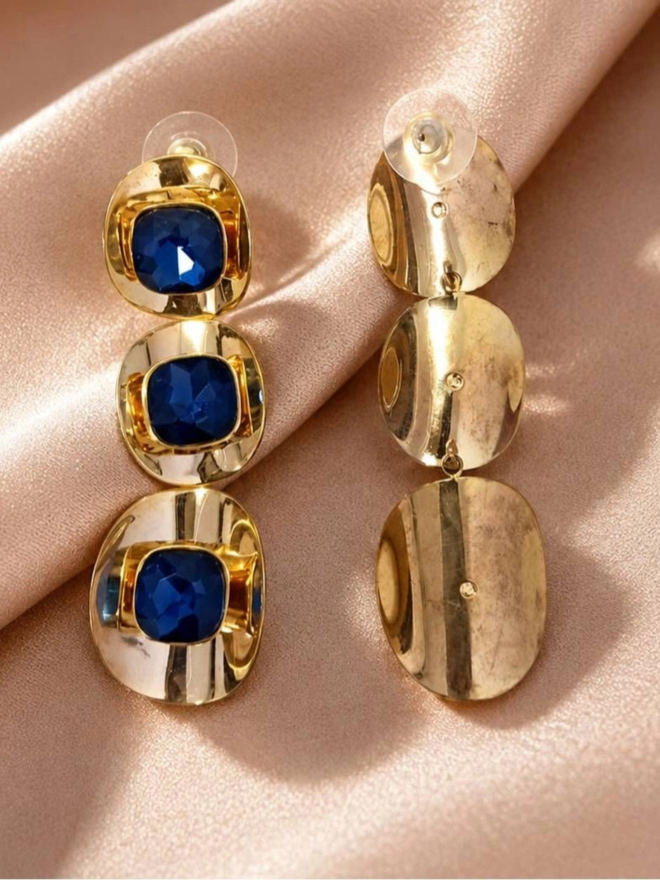 Front and back view of blue crystal drop earrings on satin, showing butterfly push-back closures