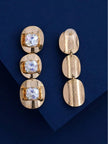 Front and back view of gold-plated three-tier crystal drop earrings against a navy blue background