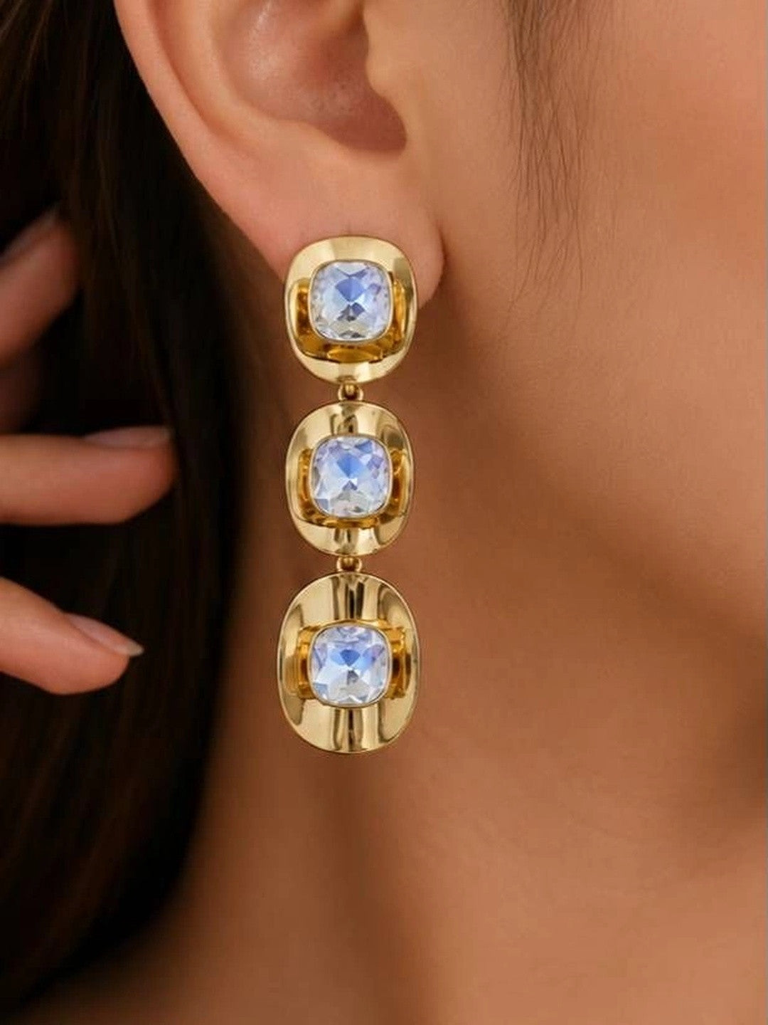 Model wearing gold-plated crystal drop earrings showing full length and scale on ear
