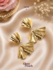 Pair of gold-plated ridged bow earrings with crystal centre on champagne satin fabric