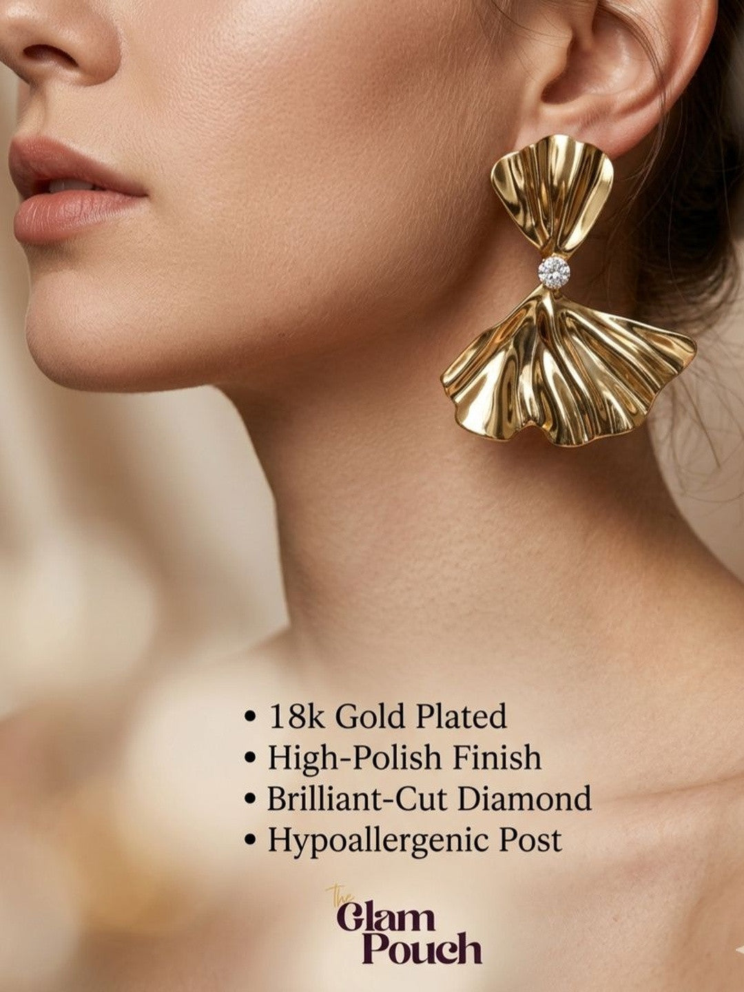Model wearing oversized gold bow earring on ear showing scale and drape
