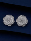 Pair of silver-finish rose stud earrings with textured mesh petals on a navy background