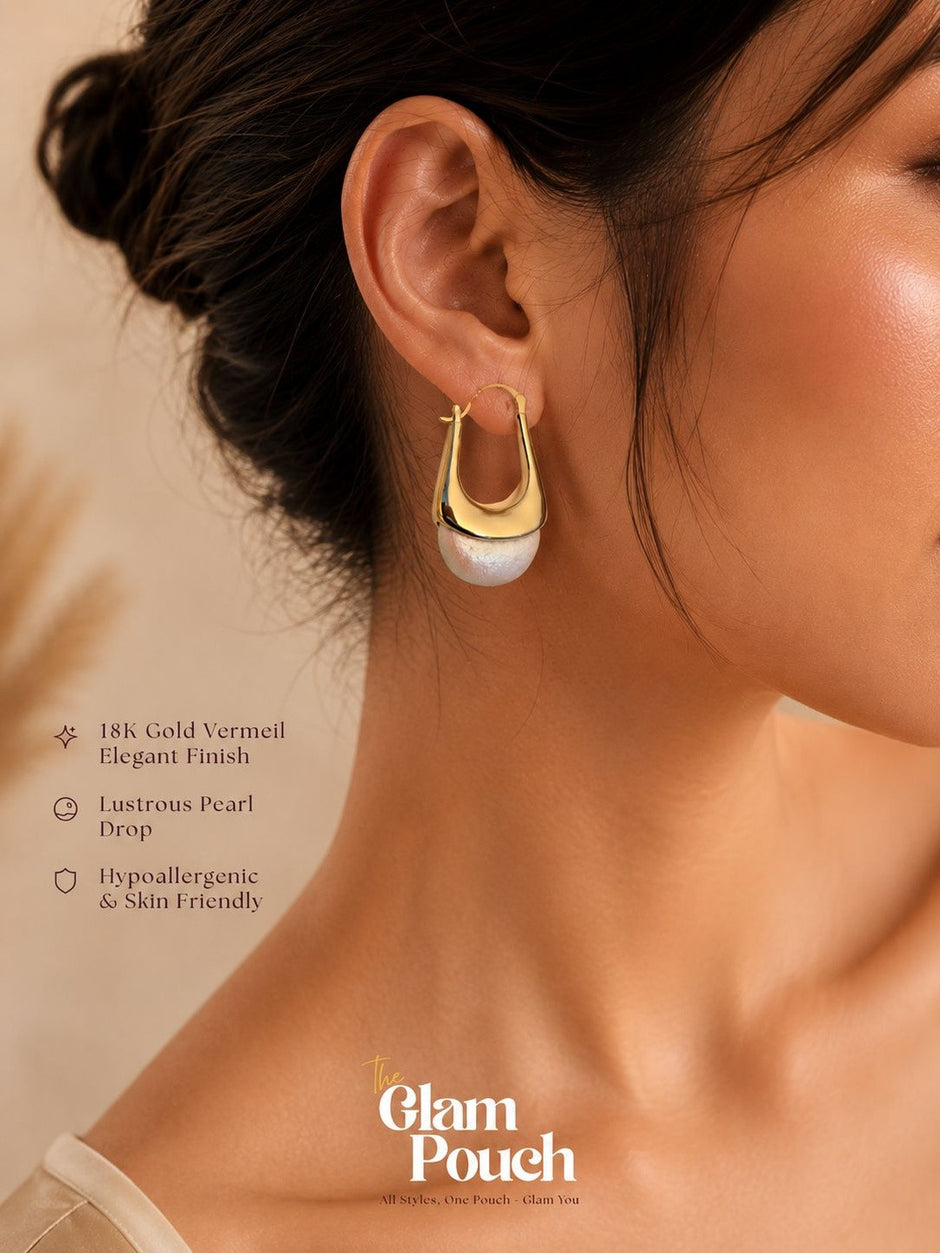 Model wearing one gold vermeil pearl drop hoop earring on right ear, side profile view