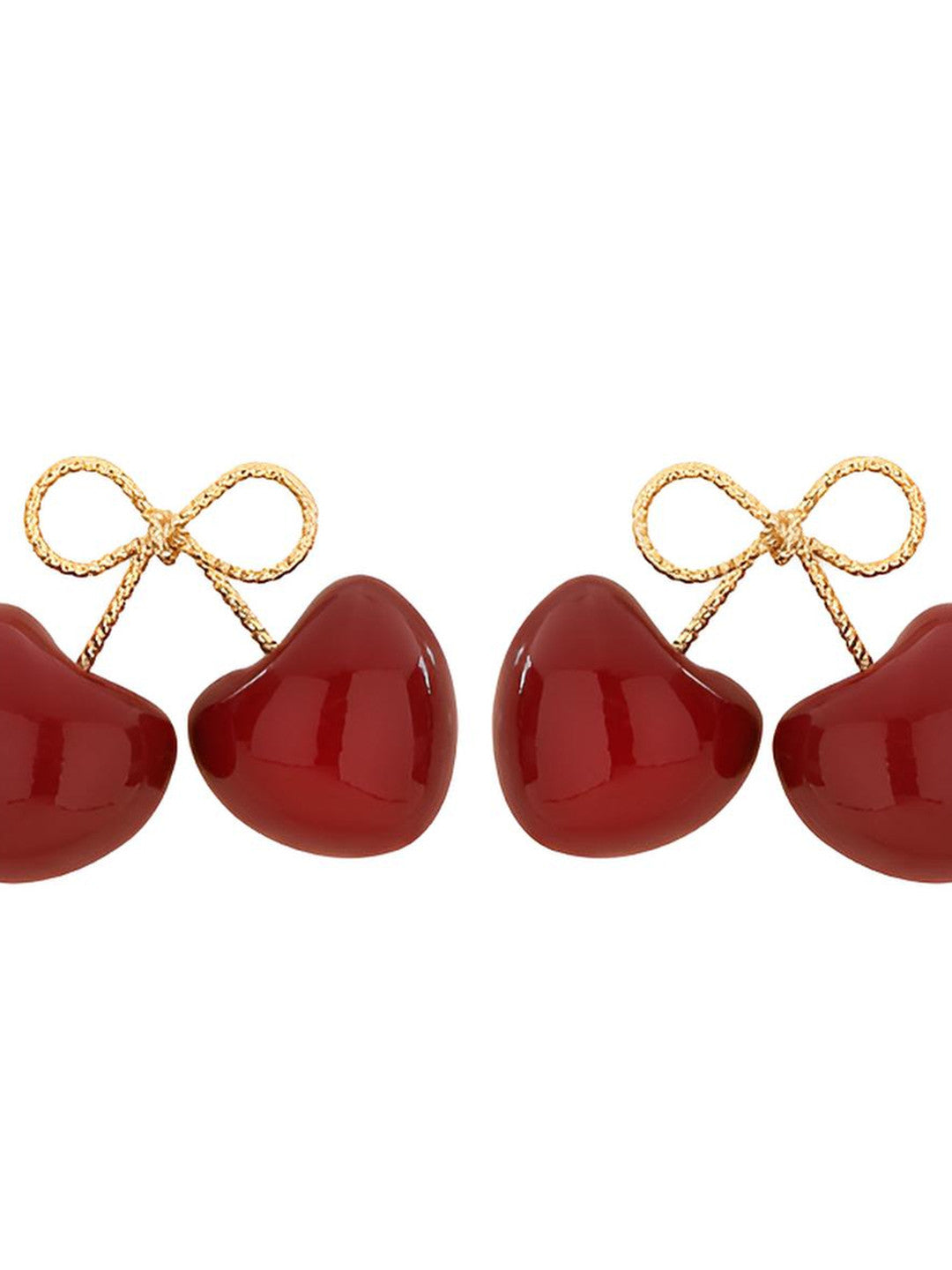 Close-up of two red enamel cherry double-drop earrings with gold-toned twisted-wire bows on a white background