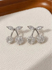 Pair of silver-finish cherry stud earrings with zirconia crystal spheres and marquise leaf accents on cream fabric