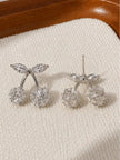 Front and back view of silver cherry stud earrings showing stud post and crystal detailing on cream background