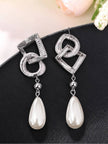 Two silver geometric drop earrings showing brushed ridged texture and pearl drops with silver ball connectors
