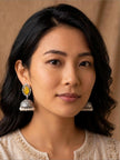 Model wearing oxidised silver yellow stone jhumka earrings paired with an ivory embroidered kurta