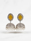 Front view of oxidised silver jhumka earrings with engraved dome and pearl fringe on a white background