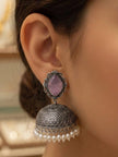 Side profile of woman wearing oxidised silver jhumka earring with lilac top and hanging pearl drops