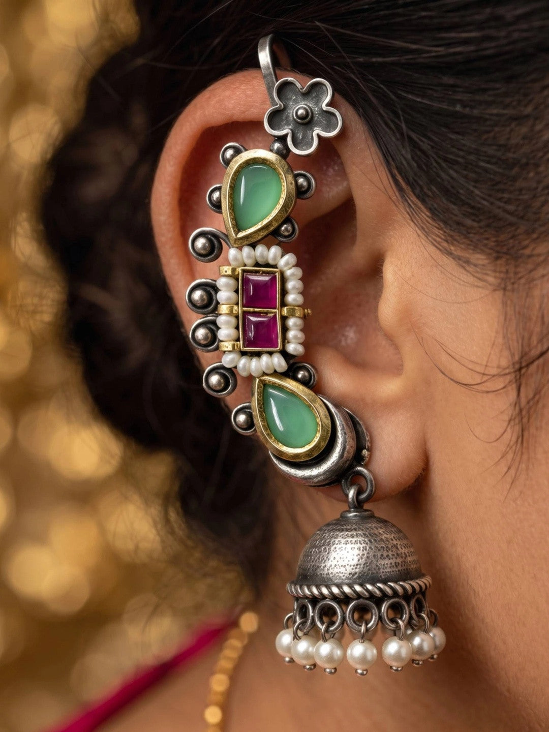 Oxidised silver ear cuff jhumka worn on a woman's ear, displaying full length from floral hook to dangling pearl jhumka bell