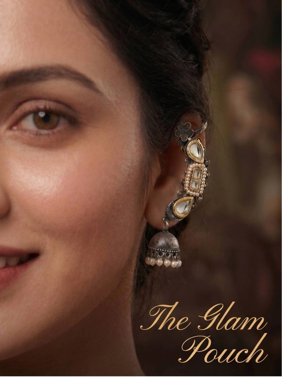 Close-up of oxidised kundan ear cuff jhumka worn on a woman's ear showing cuff placement and pearl jhumka drop