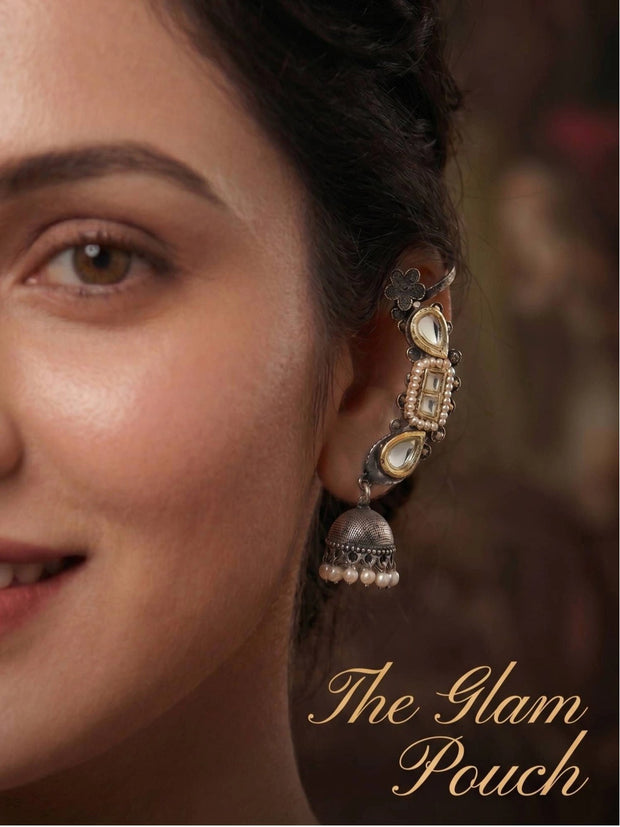 Close-up of oxidised kundan ear cuff jhumka worn on a woman's ear showing cuff placement and pearl jhumka drop