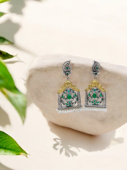 Traditional silver temple earrings with golden arch, green stone floral motifs and pearl drops for ethnic elegance.