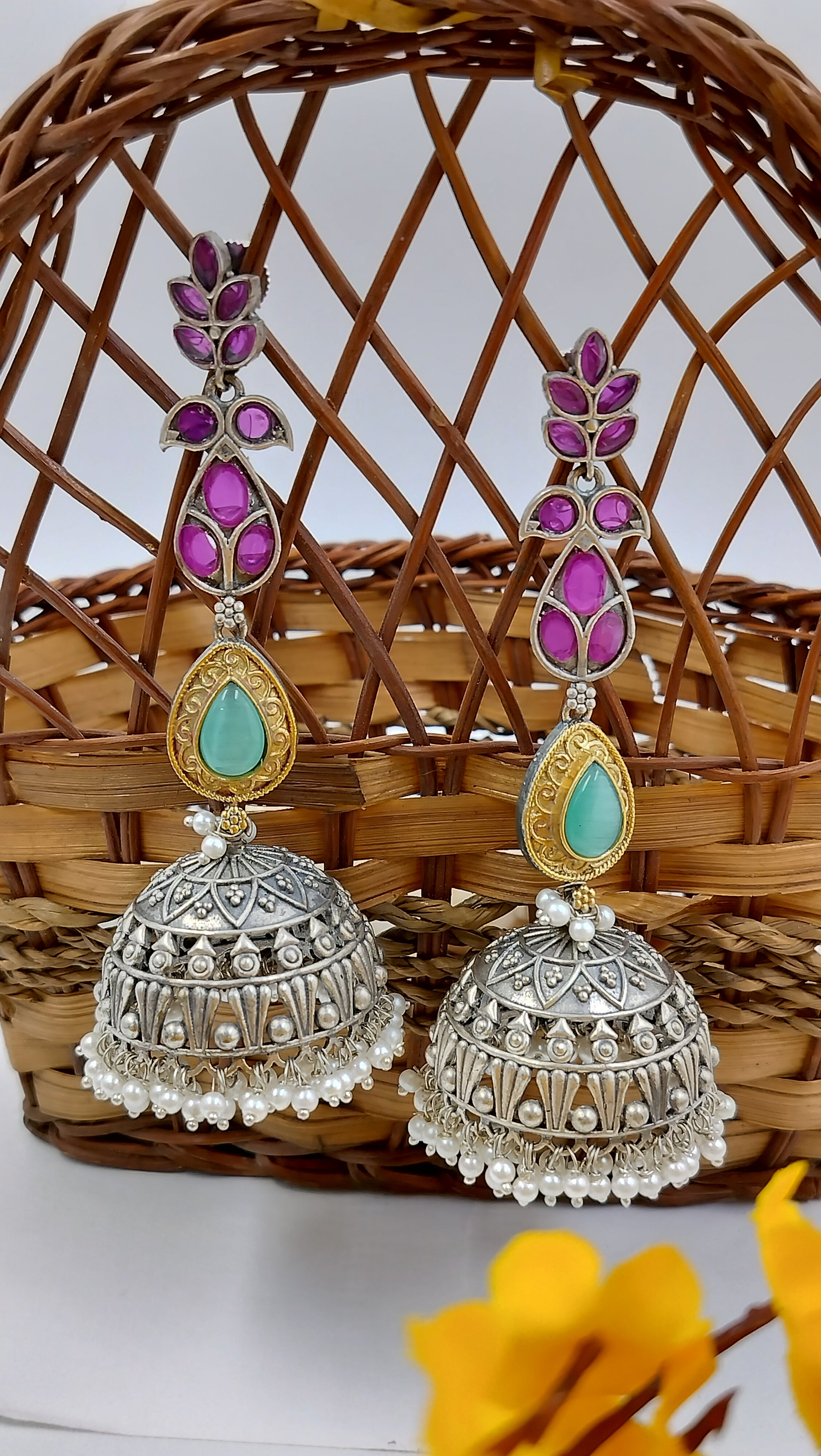 Silver dome jhumkas with purple floral tops & turquoise stone detail – a vibrant twist to your ethnic look.