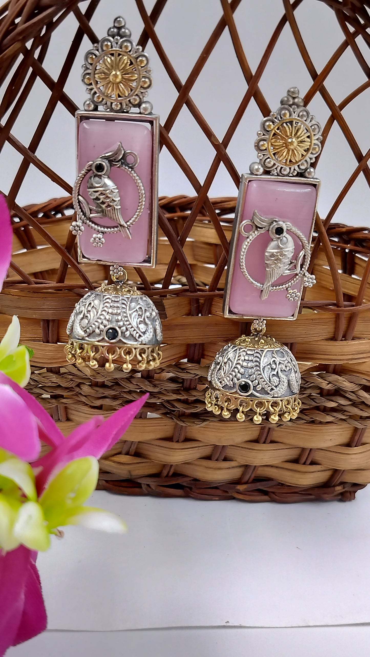 Blush pink statement jhumkas with antique bird charm – a perfect mix of elegance & tradition.