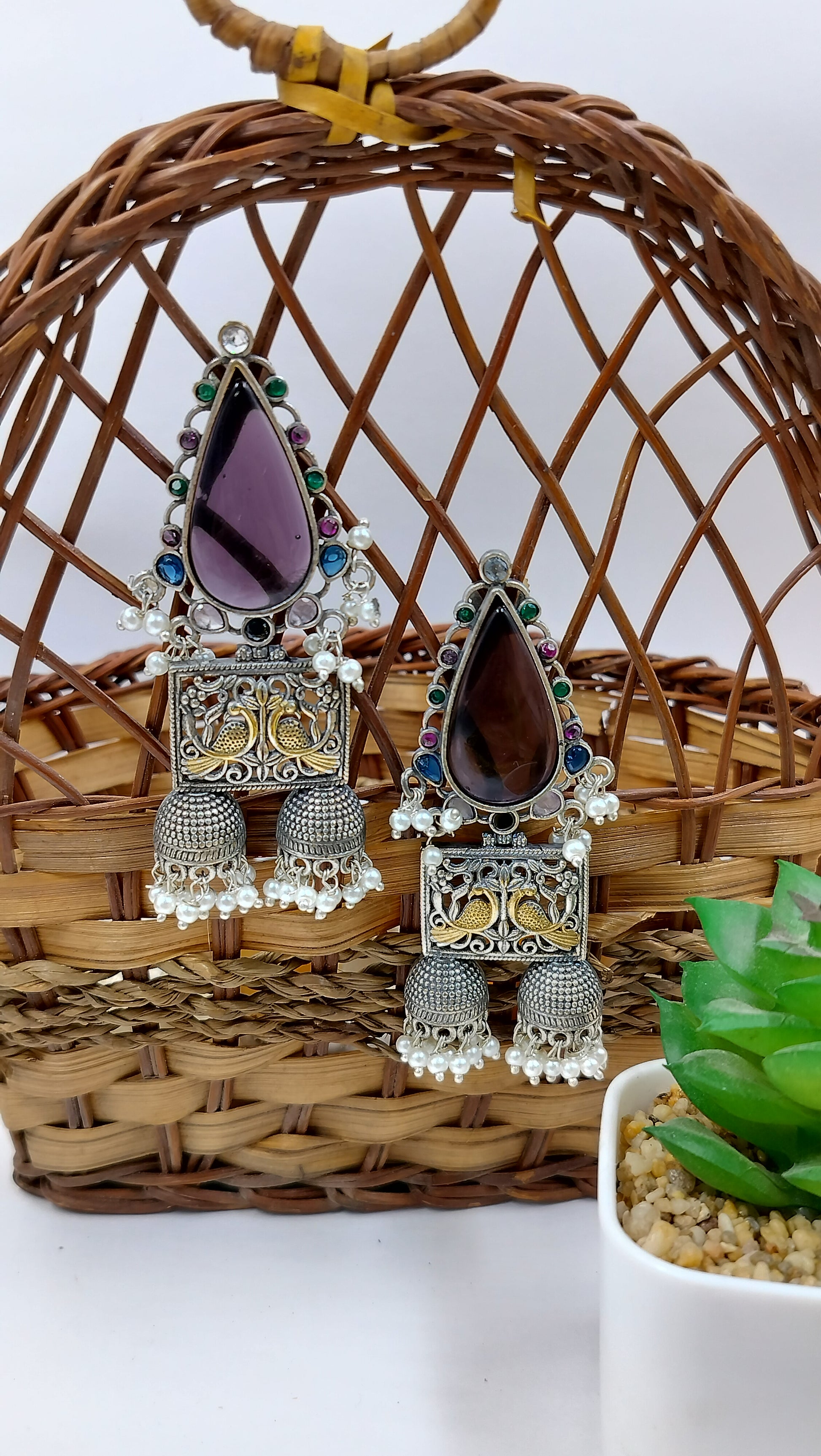 Oxidized silver earrings with purple teardrop stone, colorful accents, antique carvings and ghungroo drops.