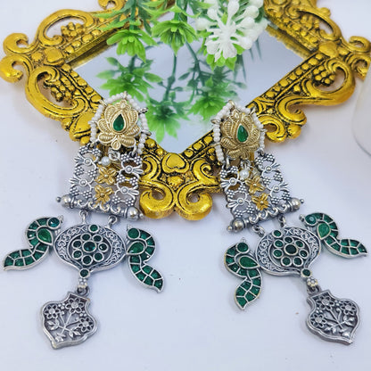 Antique silver-golden earrings with green stone detailing and intricate motifs, perfect for ethnic elegance.